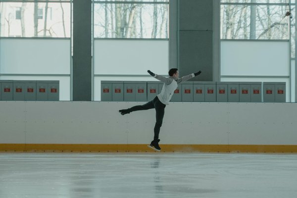 How can competitive ice skaters improve their spin technique?