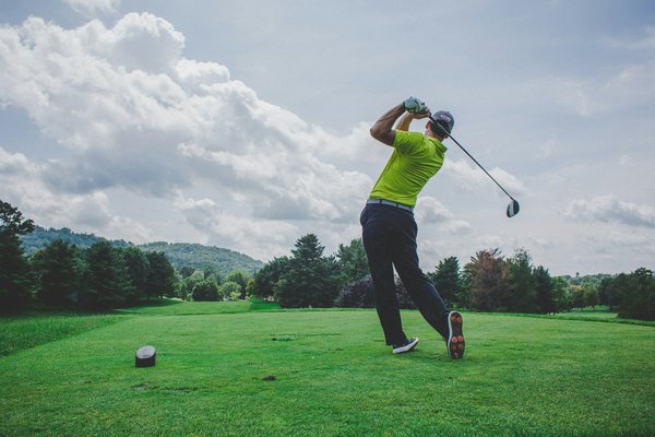 How can professional golfers enhance their swing technique through fitness training?